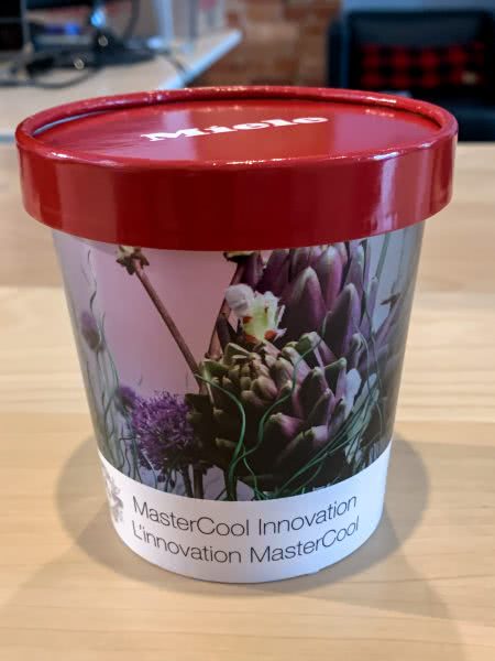 Retail custom printed ice cream container for Miele point of purchase, red lid with cup covered in flowers